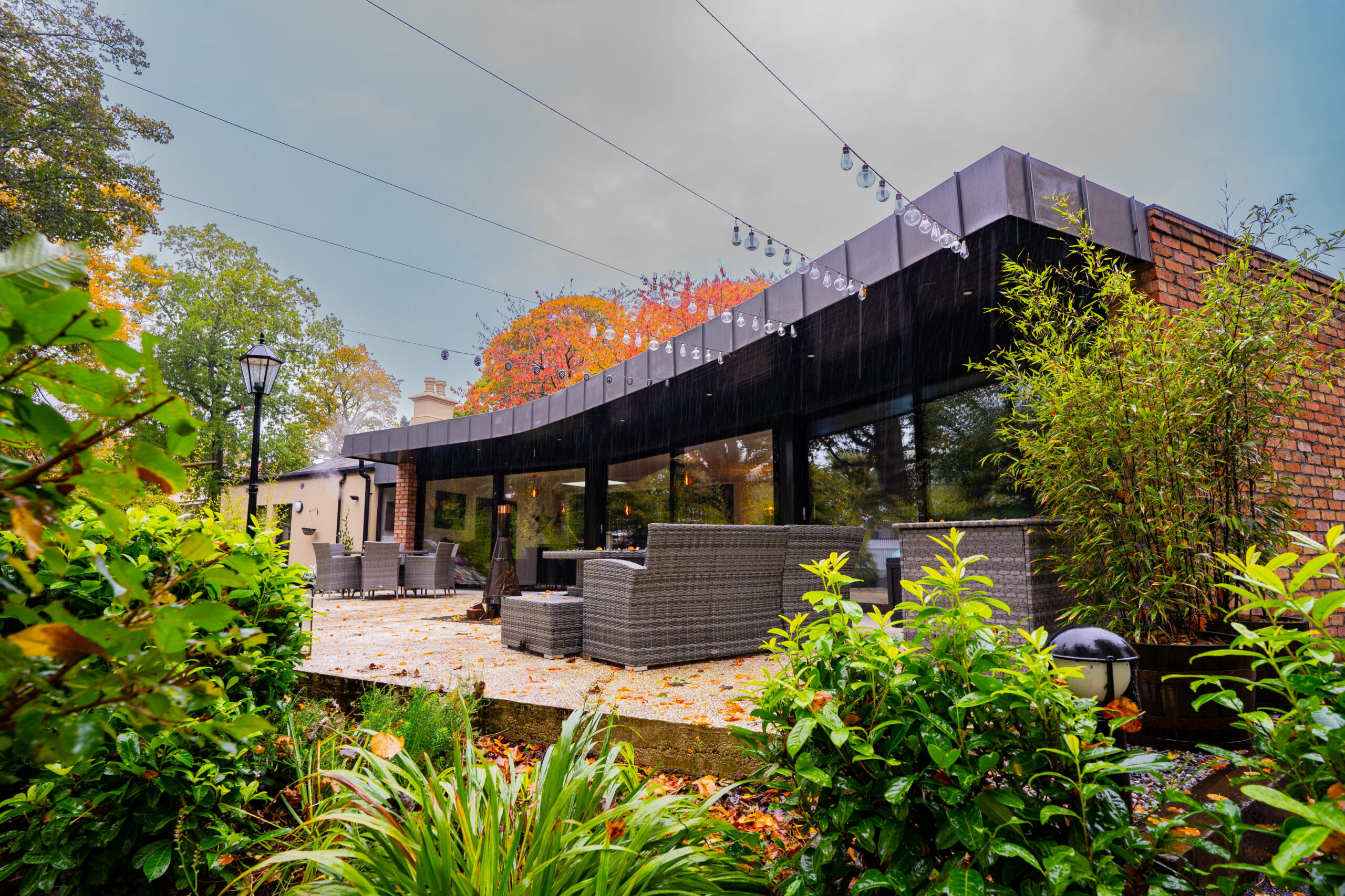 The Gatehouse curved glass panels into patio