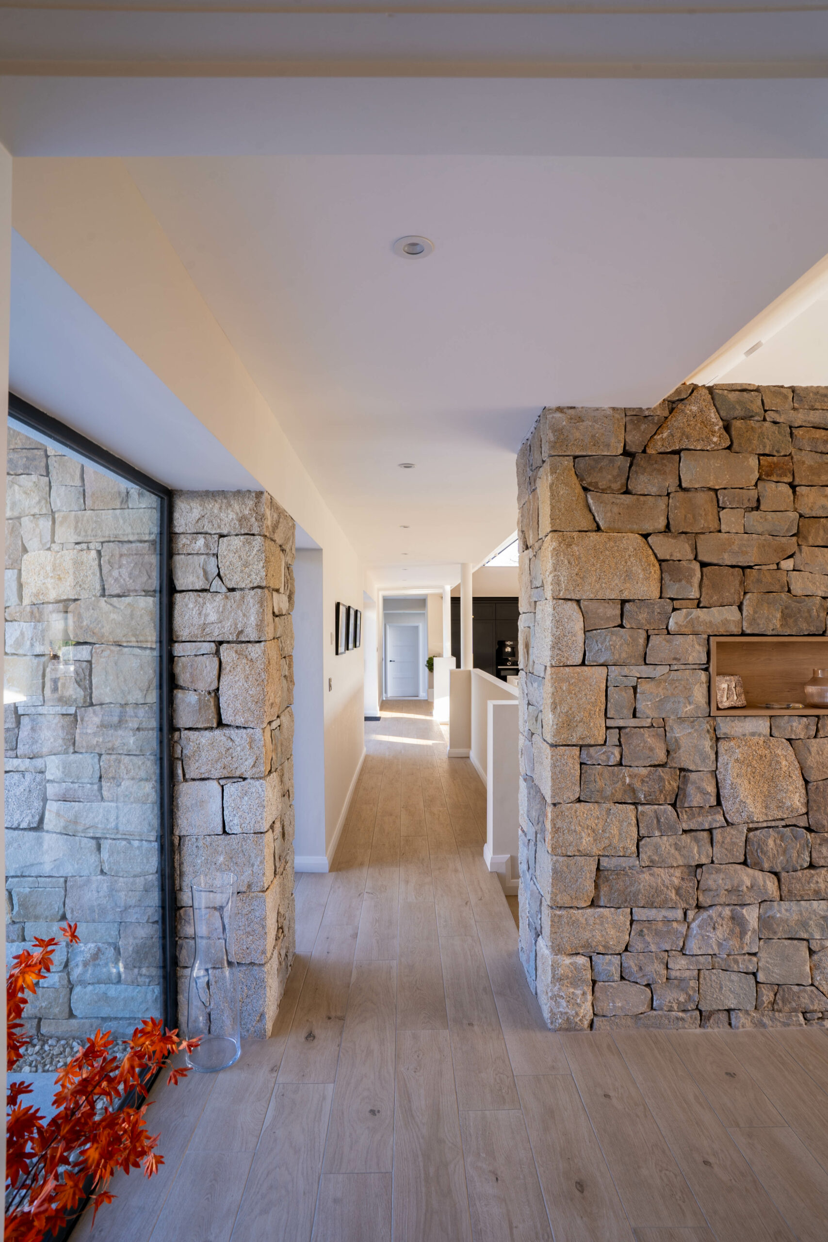 Internal photo showing stone wall and glass front