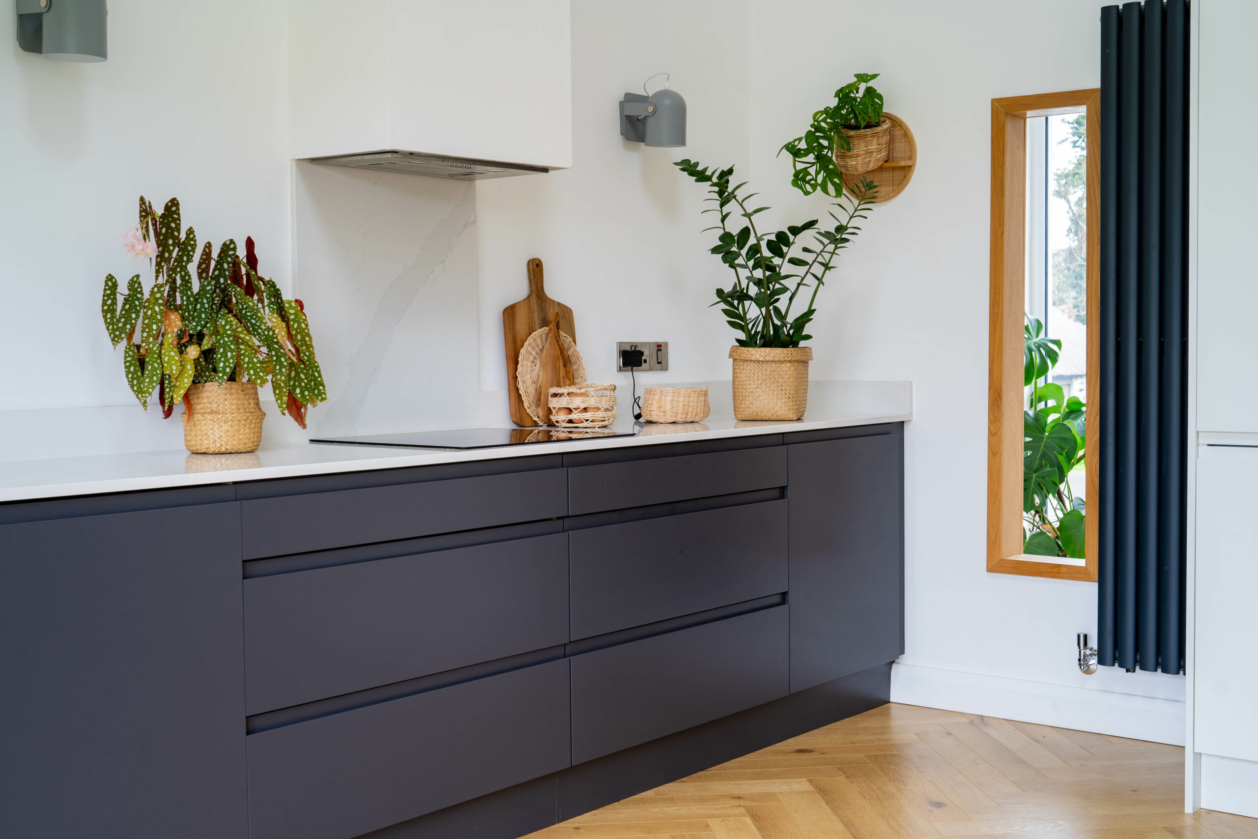 Grey kitchen with white counter, black tall radiators