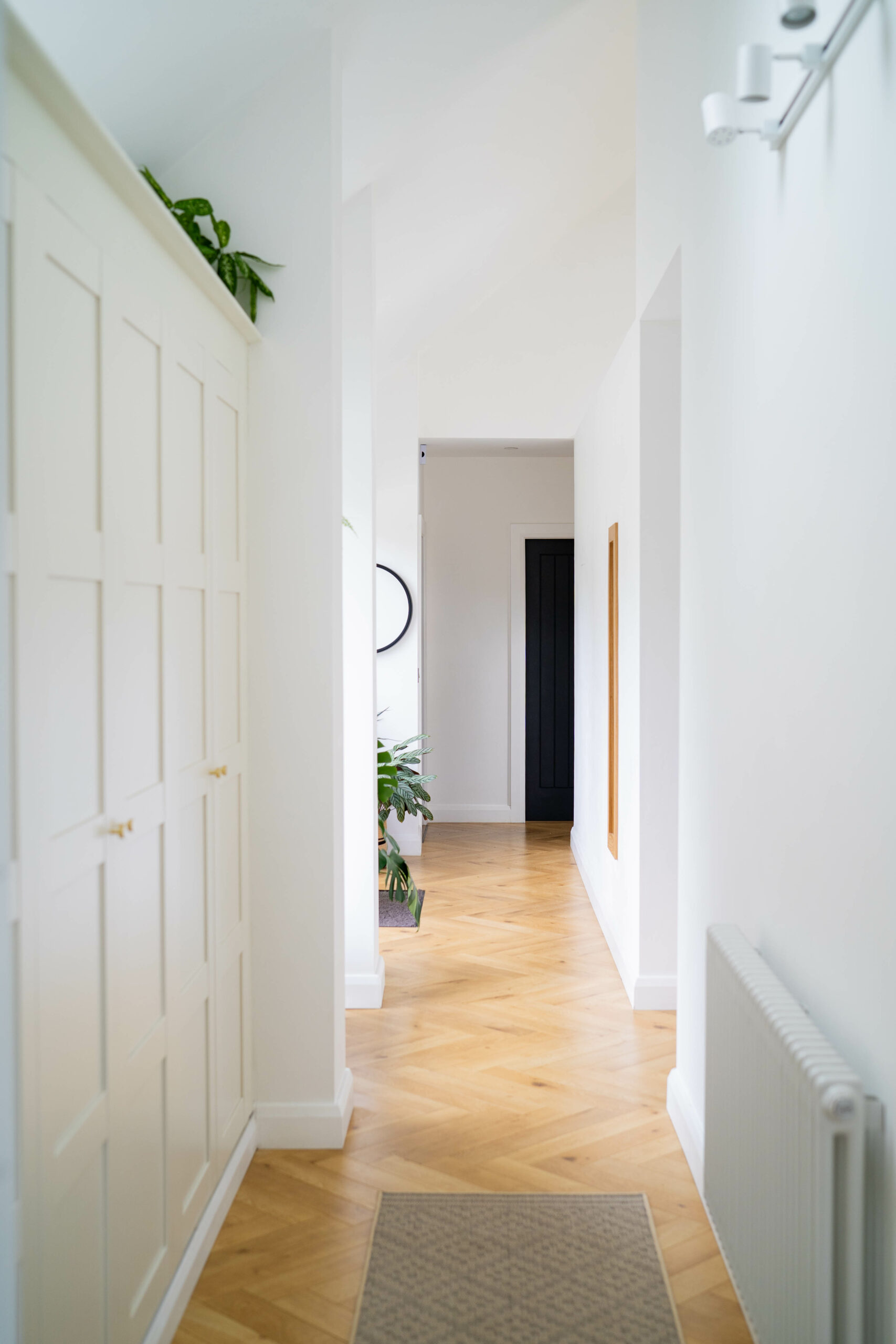 Photo of white painted hallway with wooden parquet floor